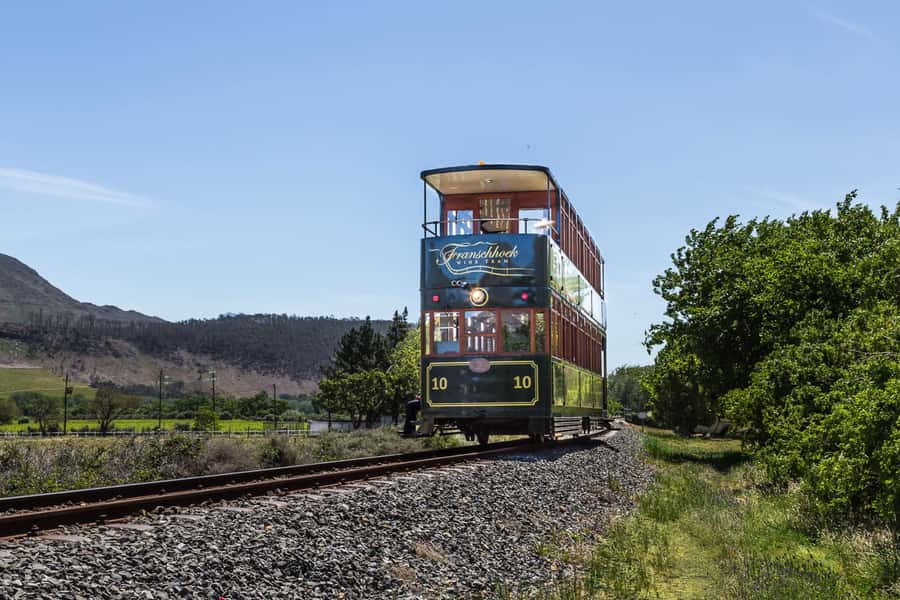 From Cape Town: Franschhoek Wine Tram Hop-on Hop-off - Wine tastings, food, and extra costs